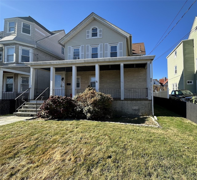 view of property featuring a front yard and a porch