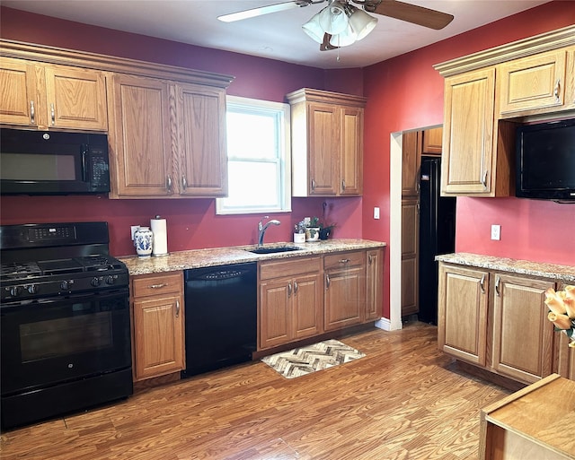 kitchen with sink, light hardwood / wood-style flooring, ceiling fan, and black appliances