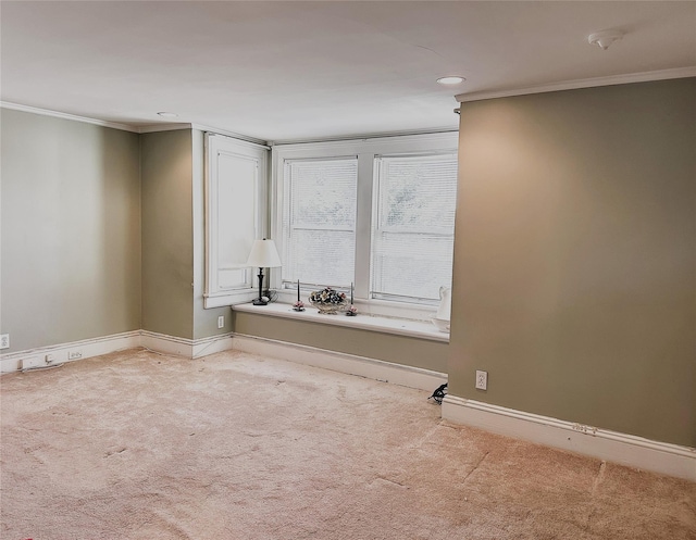 carpeted empty room featuring crown molding