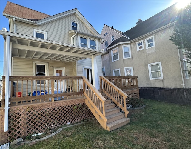 back of house featuring a yard and a deck