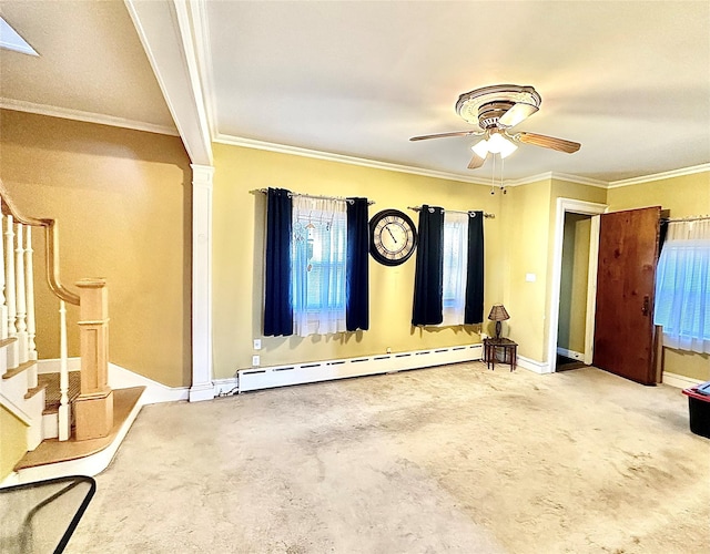 unfurnished living room featuring carpet flooring, ornamental molding, ceiling fan, and a baseboard heating unit