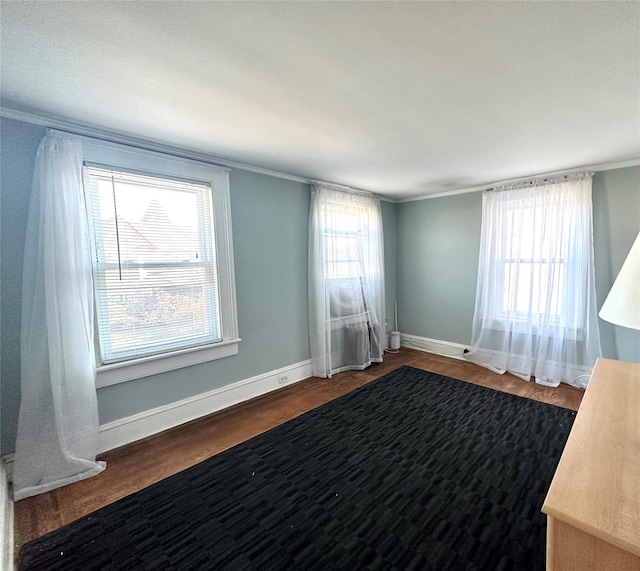 spare room with dark hardwood / wood-style floors and ornamental molding