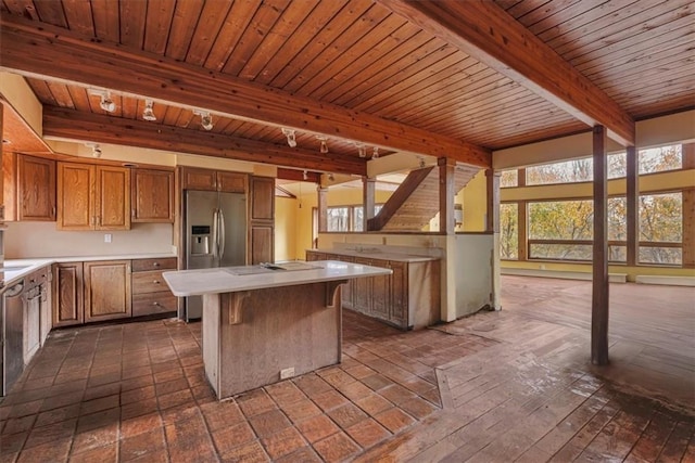 kitchen with stainless steel fridge, wood ceiling, beam ceiling, dark hardwood / wood-style floors, and a kitchen island