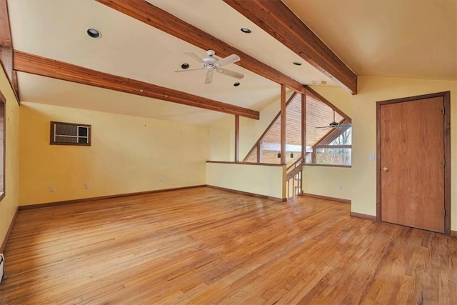 unfurnished living room with ceiling fan, lofted ceiling with beams, light hardwood / wood-style floors, and a wall unit AC