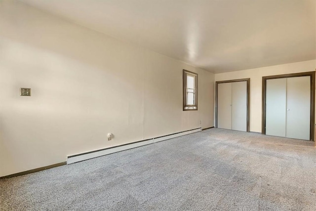 unfurnished bedroom with carpet flooring, multiple closets, and a baseboard radiator