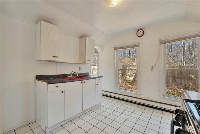 kitchen featuring white cabinets, lofted ceiling, baseboard heating, and sink