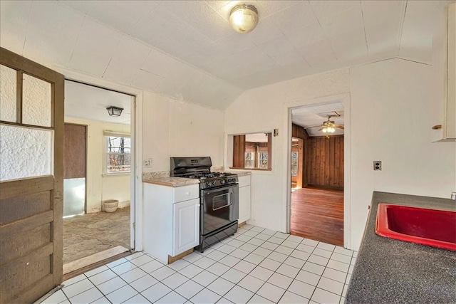 kitchen with lofted ceiling, sink, light hardwood / wood-style flooring, white cabinetry, and black range with gas cooktop