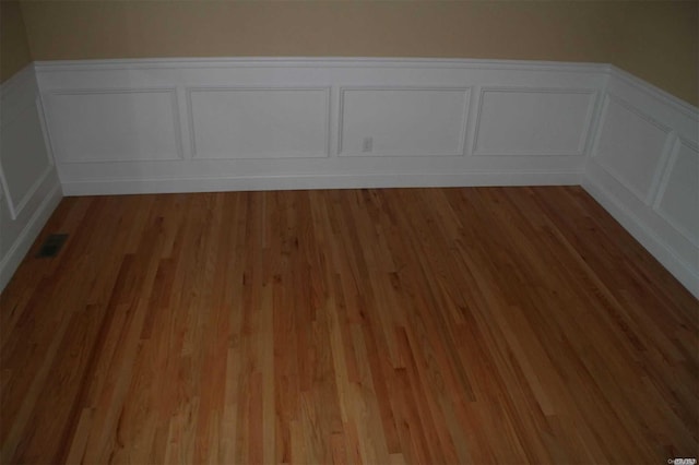 unfurnished room featuring wood-type flooring