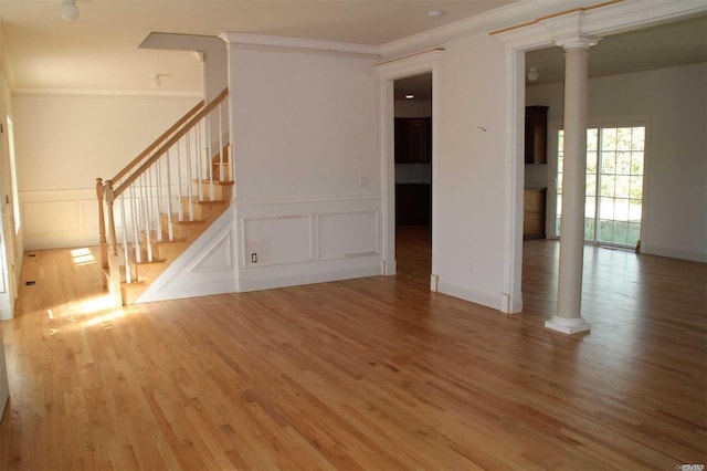 unfurnished living room with wood-type flooring and crown molding