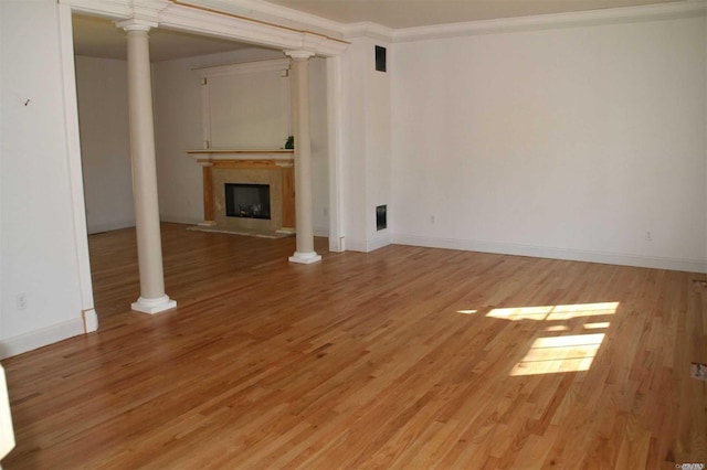 unfurnished living room with hardwood / wood-style floors and ornamental molding