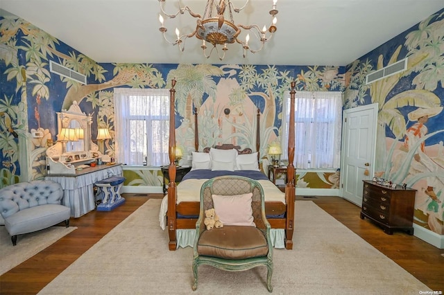 bedroom with a chandelier and dark hardwood / wood-style floors