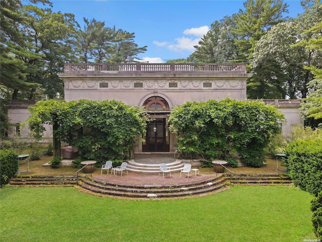 view of front of home featuring french doors and a front lawn