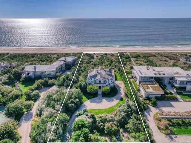 drone / aerial view featuring a view of the beach and a water view