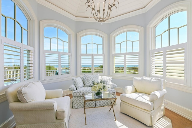 sunroom / solarium with a chandelier