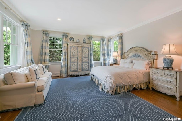 bedroom featuring hardwood / wood-style flooring and ornamental molding