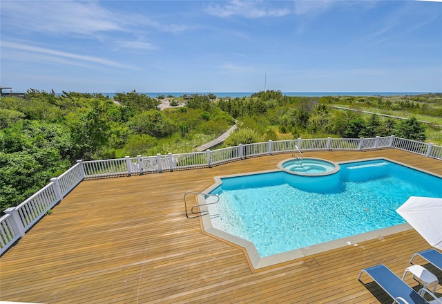 view of pool with an in ground hot tub and a deck with water view