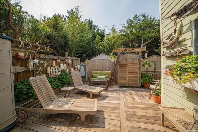 wooden terrace featuring a storage unit