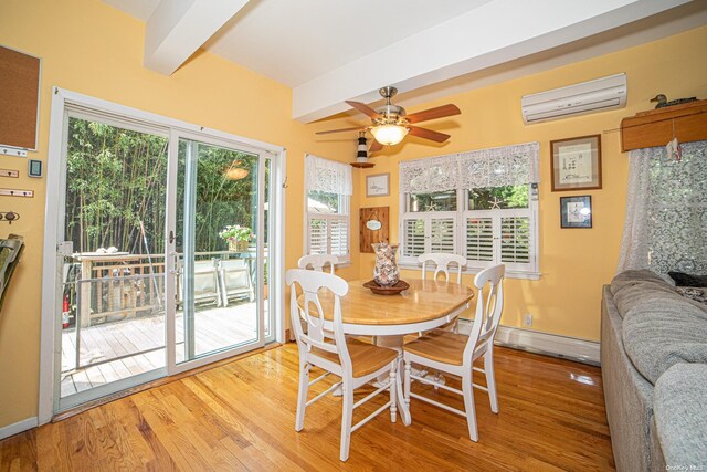 dining area featuring a wall mounted air conditioner, ceiling fan, baseboard heating, beamed ceiling, and light hardwood / wood-style floors