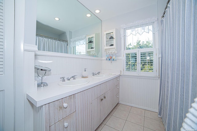 bathroom with tile patterned flooring and vanity