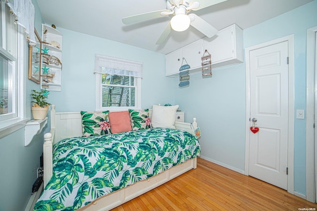 bedroom with light hardwood / wood-style floors and ceiling fan