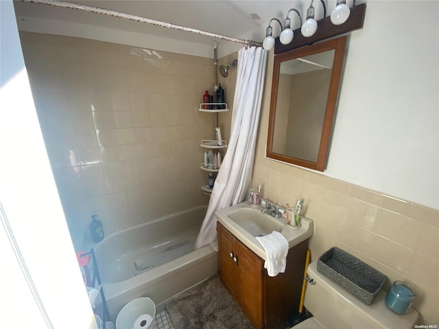 full bathroom featuring shower / bath combo, toilet, tile walls, and vanity