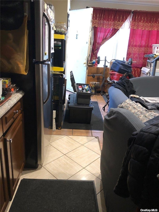 kitchen with stainless steel fridge and light tile patterned flooring