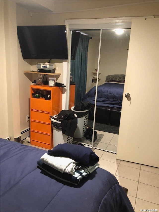 tiled bedroom featuring a closet