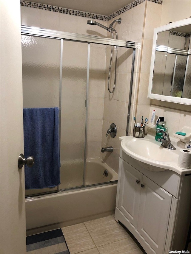 bathroom with vanity and bath / shower combo with glass door