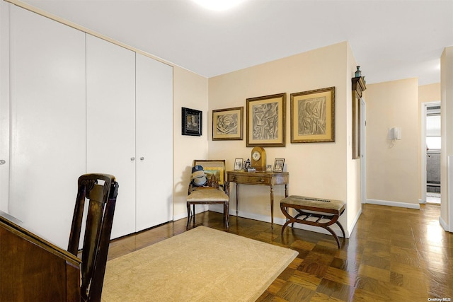 sitting room featuring dark parquet floors