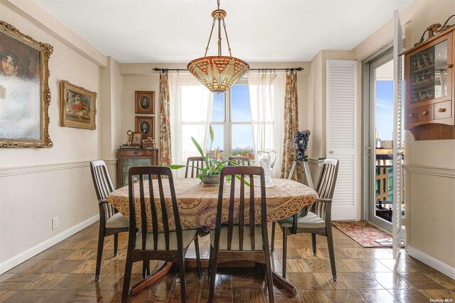 dining space with an inviting chandelier and a healthy amount of sunlight