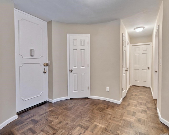 foyer featuring dark parquet flooring