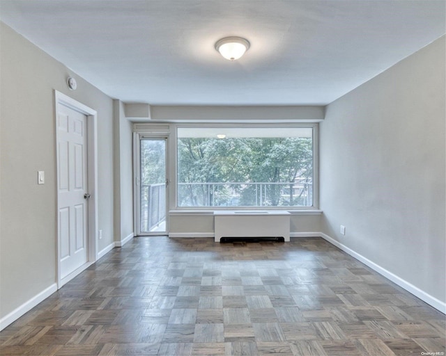 unfurnished room featuring dark parquet floors