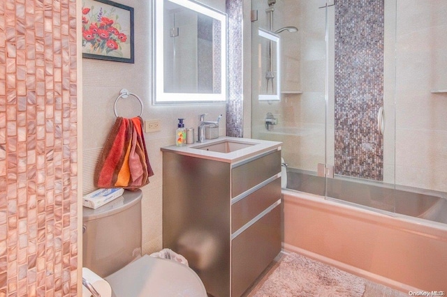 full bathroom with vanity, toilet, and tiled shower / bath