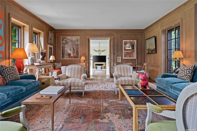 living room with wood walls and a wealth of natural light