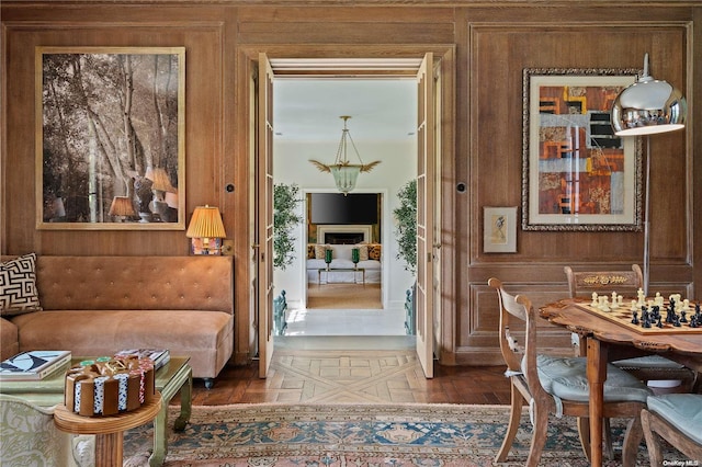 doorway to outside with hardwood / wood-style flooring and wood walls