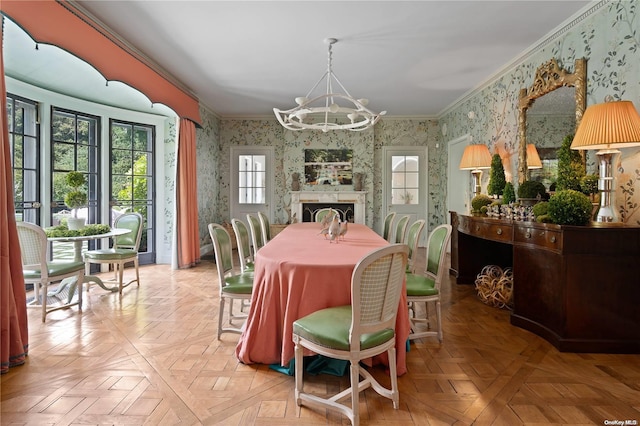 dining space with an inviting chandelier, light parquet flooring, and ornamental molding