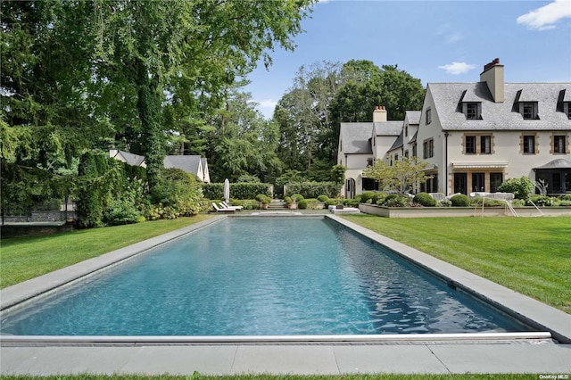 view of pool with a yard