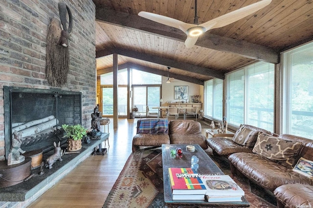 living room featuring hardwood / wood-style floors, wooden ceiling, lofted ceiling with beams, ceiling fan, and a fireplace