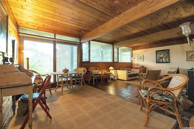 sunroom featuring beam ceiling and wooden ceiling