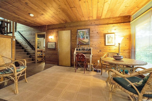 sitting room featuring wooden ceiling and wooden walls