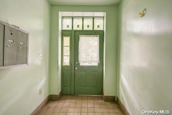 entryway with light tile patterned floors