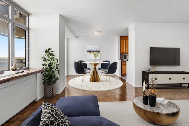 living room featuring dark parquet flooring