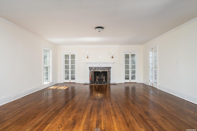 unfurnished living room with dark hardwood / wood-style flooring, ornamental molding, and a premium fireplace