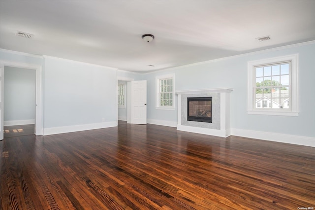 unfurnished living room with crown molding and dark wood-type flooring