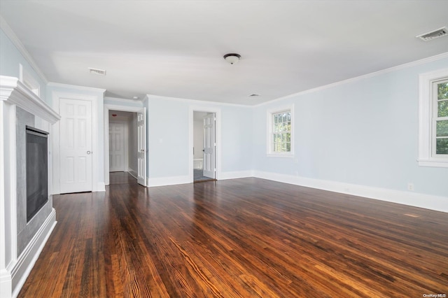 unfurnished living room with crown molding and dark wood-type flooring