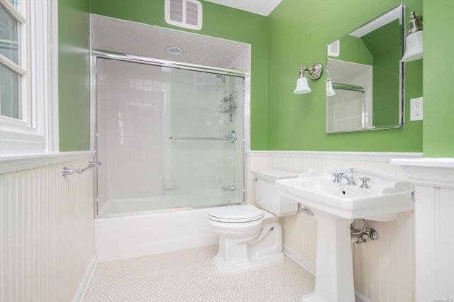 full bathroom with tile patterned floors, toilet, enclosed tub / shower combo, and sink