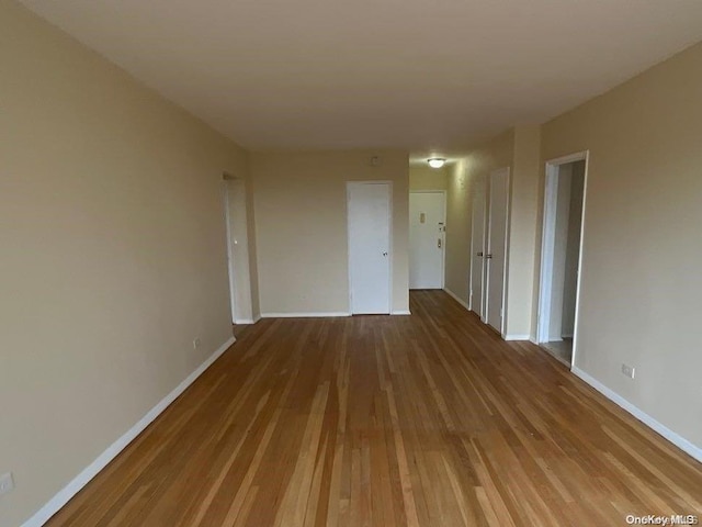 unfurnished room featuring hardwood / wood-style floors