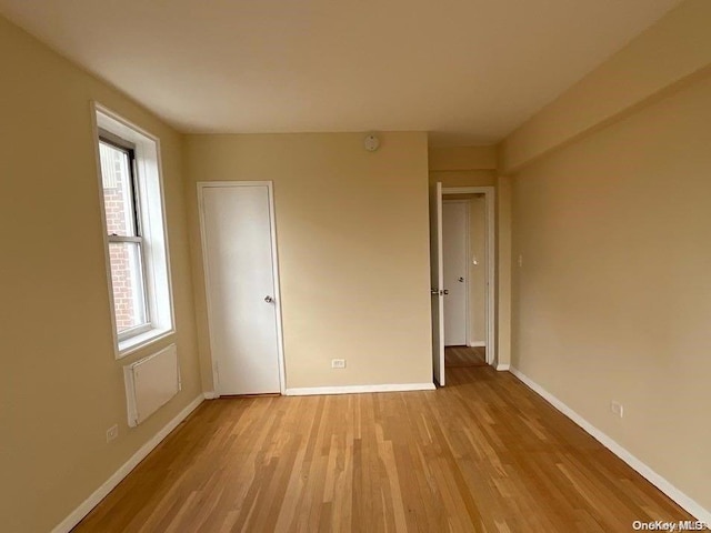 unfurnished bedroom featuring light hardwood / wood-style floors and multiple windows