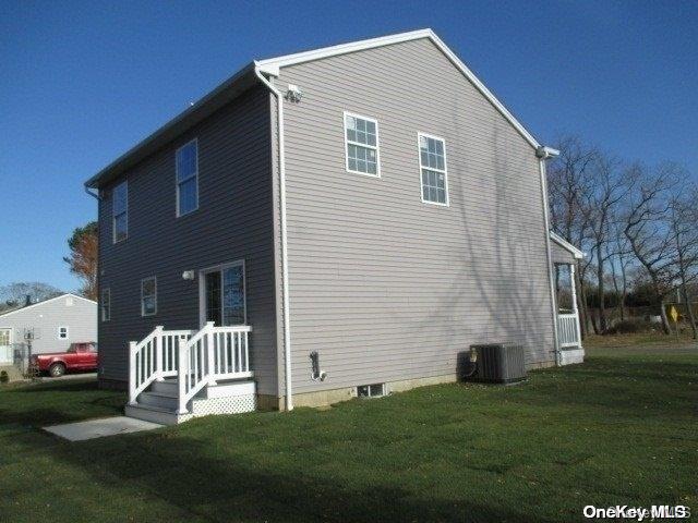 exterior space with a yard and central AC