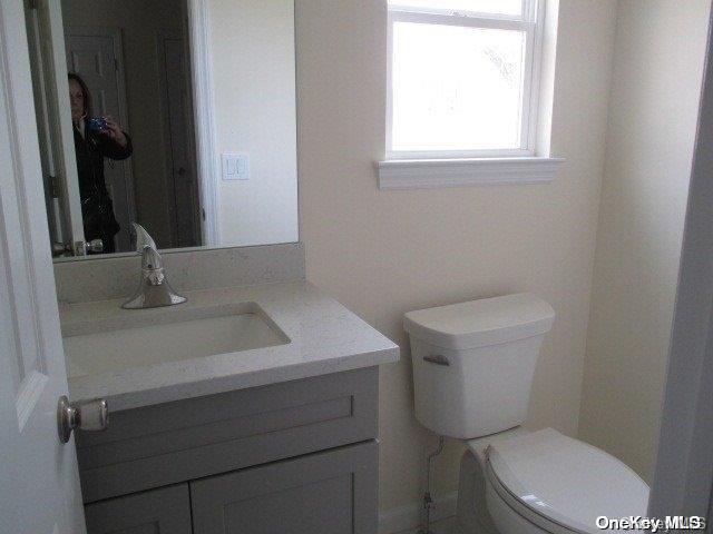 bathroom featuring vanity and toilet